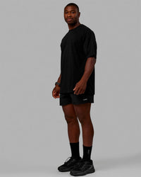 Man wearing Unisex Stamped 2.0 Heavyweight Tee Oversize - Black