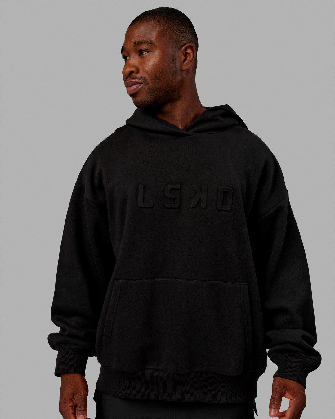 Man wearing Unisex Stamped Hoodie Oversize - Black