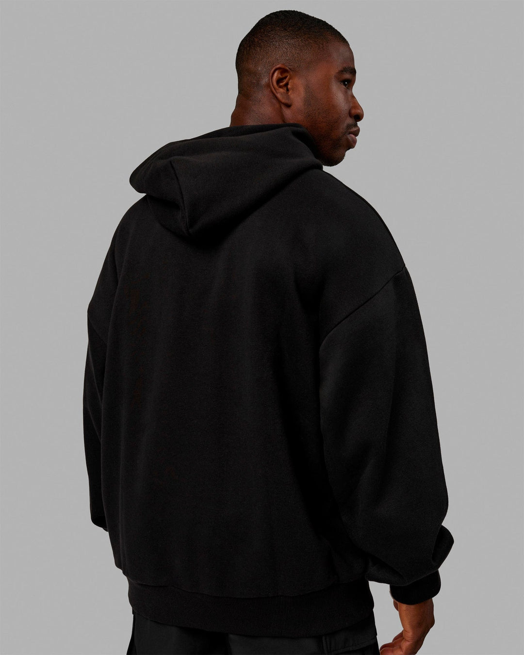 Man wearing Unisex Stamped Hoodie Oversize - Black