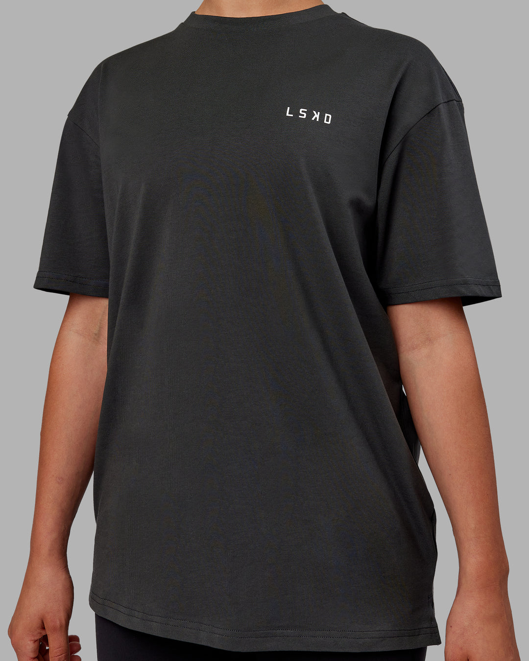Woman wearing Unisex Strike Through FLXCotton Tee Oversize - Pirate Black-Black