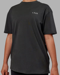 Woman wearing Unisex Strike Through FLXCotton Tee Oversize - Pirate Black-Black