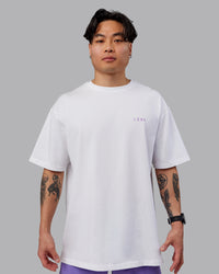 Man wearing Unisex Strike Through FLXCotton Tee Oversize - White-Purple Swirl