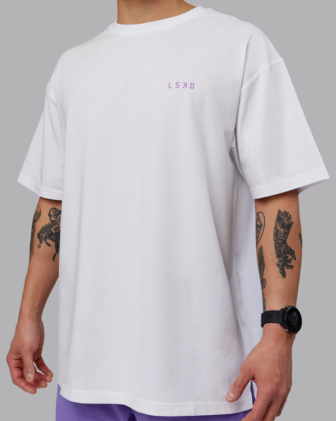 Man wearing Unisex Strike Through FLXCotton Tee Oversize - White-Purple Swirl
