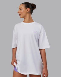 Woman wearing Unisex Strike Through FLXCotton Tee Oversize - White-Purple Swirl