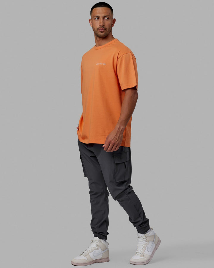 Man wearing Unisex Taylor Tee Oversize - Tangerine