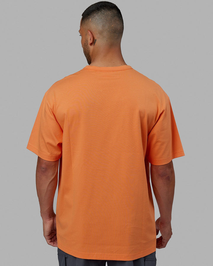 Man wearing Unisex Taylor Tee Oversize - Tangerine