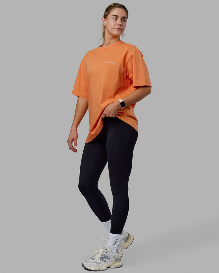 Woman wearing Unisex Taylor Tee Oversize - Tangerine