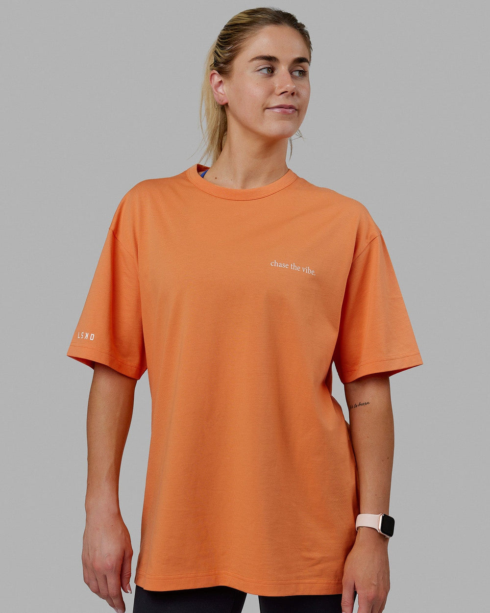 Woman wearing Unisex Taylor Tee Oversize - Tangerine