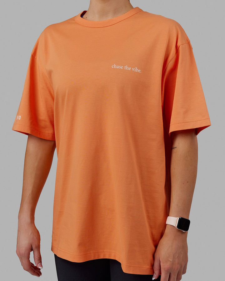 Woman wearing Unisex Taylor Tee Oversize - Tangerine