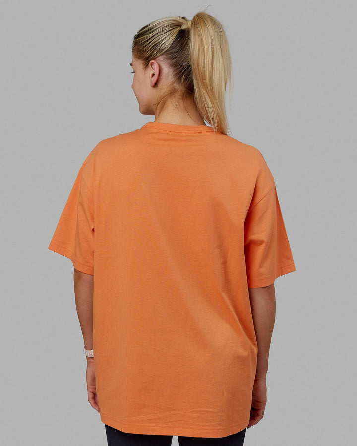 Woman wearing Unisex Taylor Tee Oversize - Tangerine