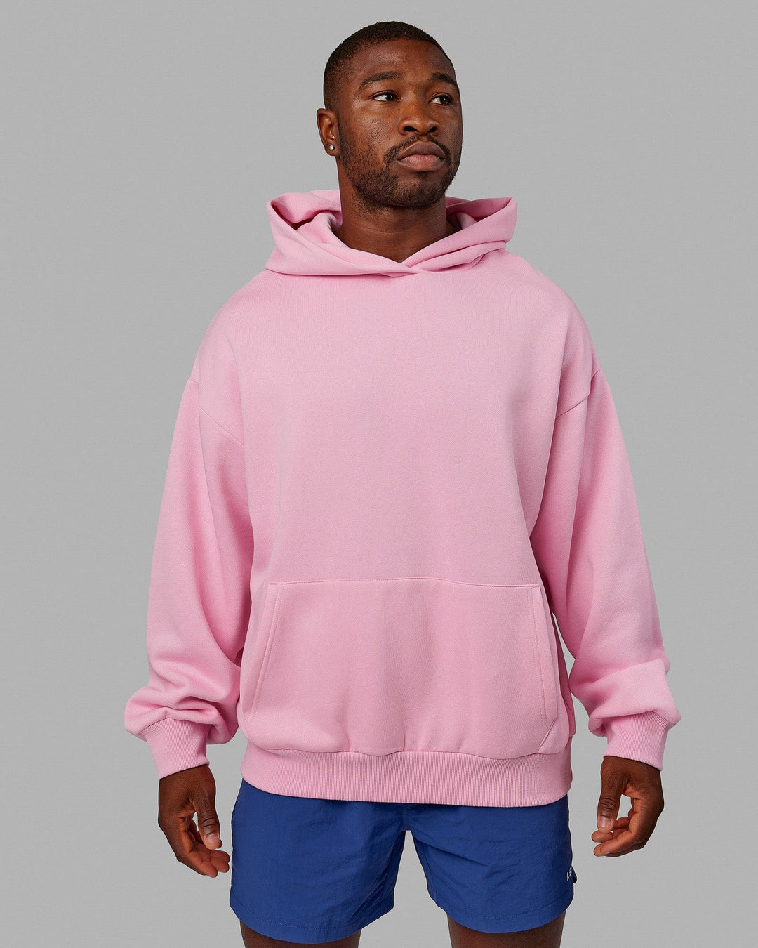 Man wearing wearing Unisex Urban Hoodie Oversize - Pink Frosting-Galactic Blue