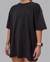 Woman wearing Unisex Washed RUN CLUB FLXCotton Tee Oversize - Black-Black