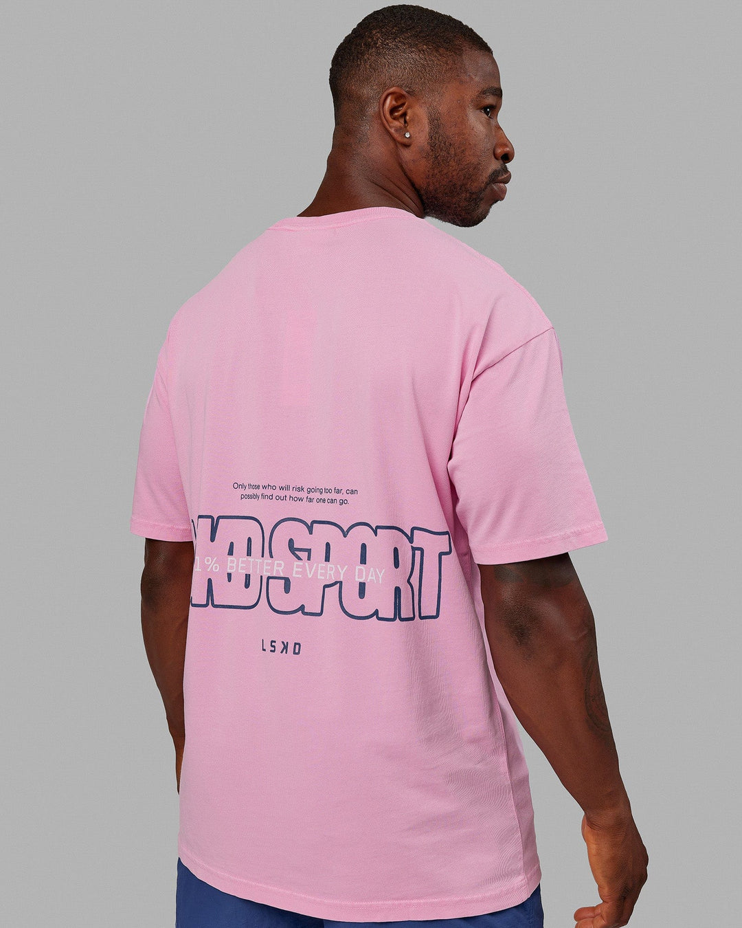Man wearing Unisex Washed Urban Heavyweight Tee Oversize - Pink Frosting-Galactic Blue