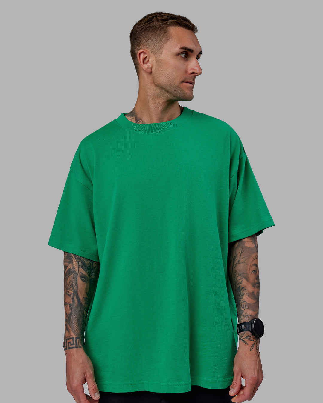 Man wearing Unisex We Rise Heavyweight Tee Oversize - Impact Green-White