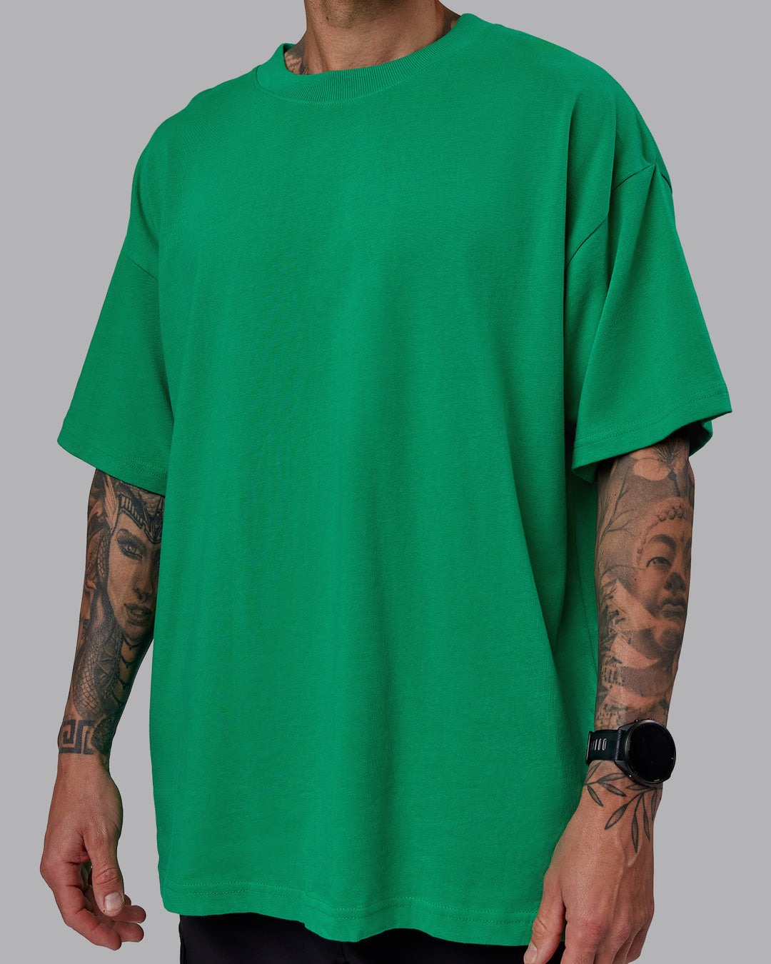 Man wearing Unisex We Rise Heavyweight Tee Oversize - Impact Green-White