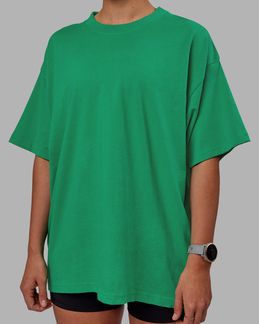 Woman wearing Unisex We Rise Heavyweight Tee Oversize - Impact Green-White