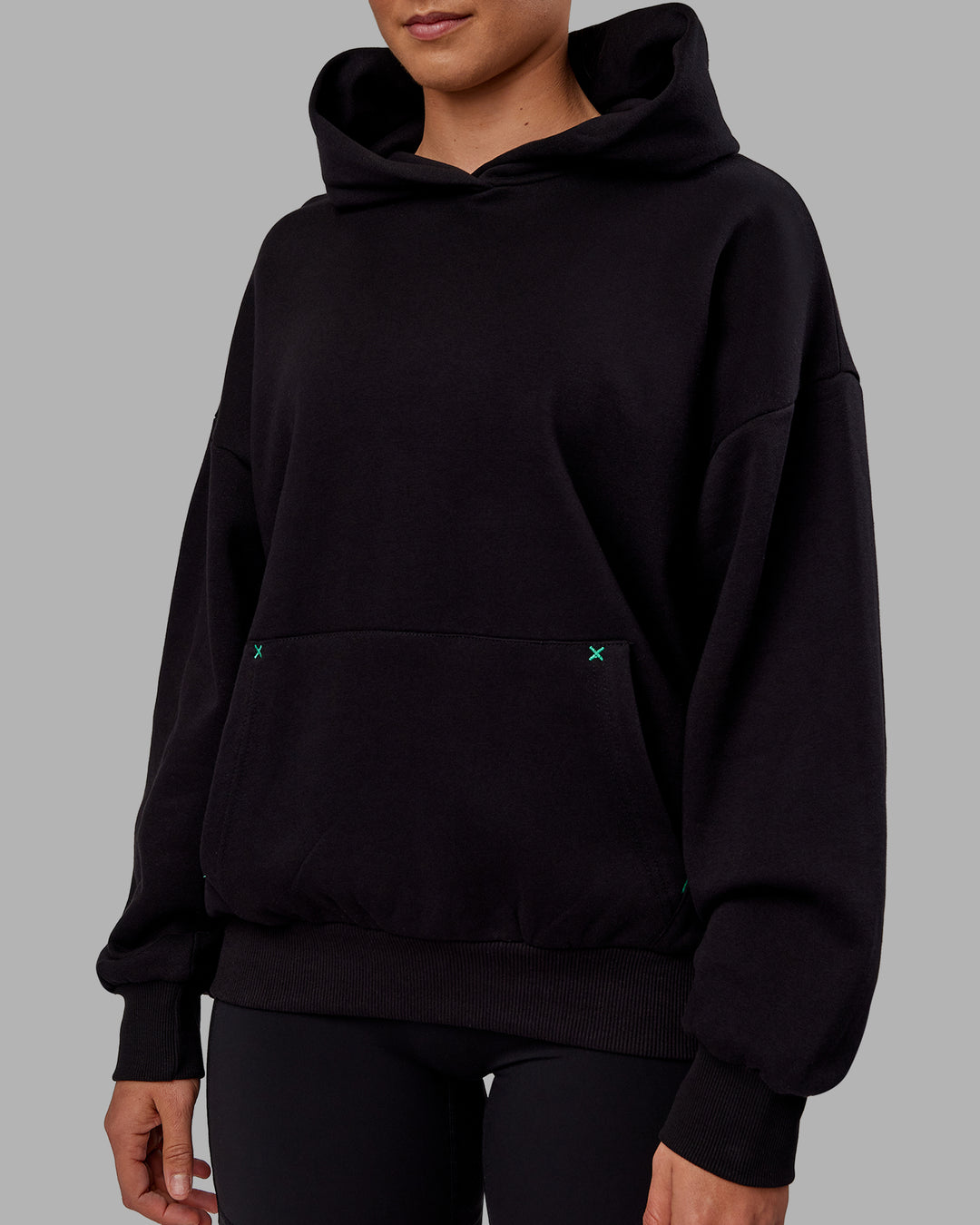 Woman wearing Unisex We Rise Hoodie Oversize - Black-Impact Green