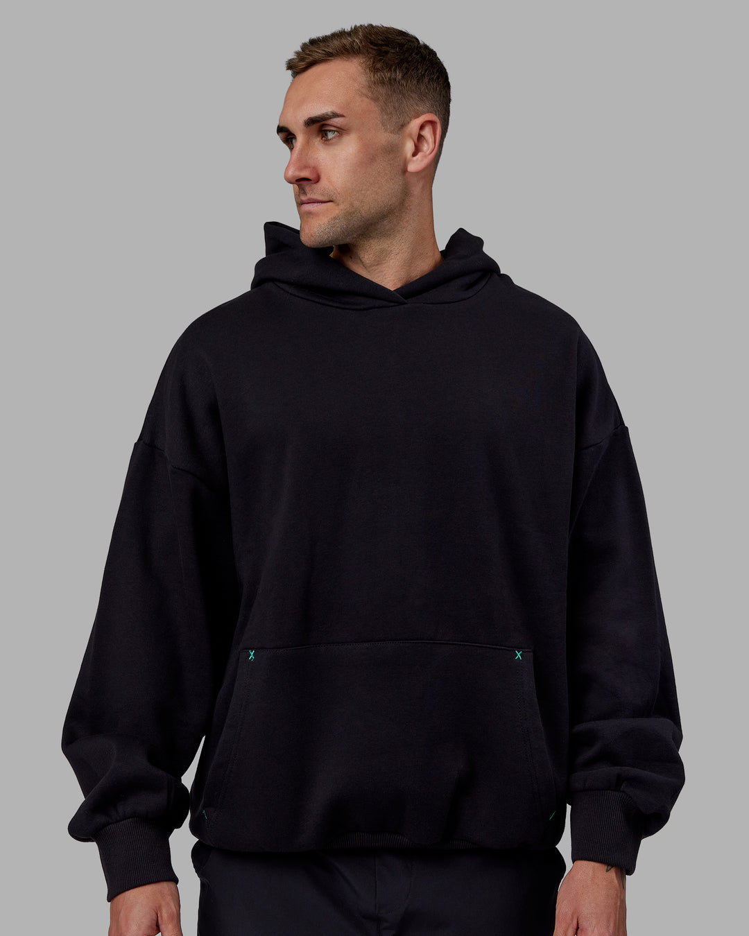 Man wearing Unisex We Rise Hoodie Oversize - Black-Impact Green