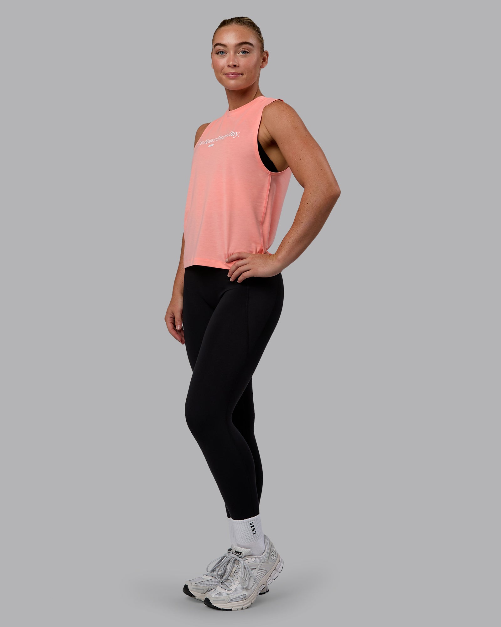 Woman wearing Unleash 1% Better Training Tank - Murex Shell-White