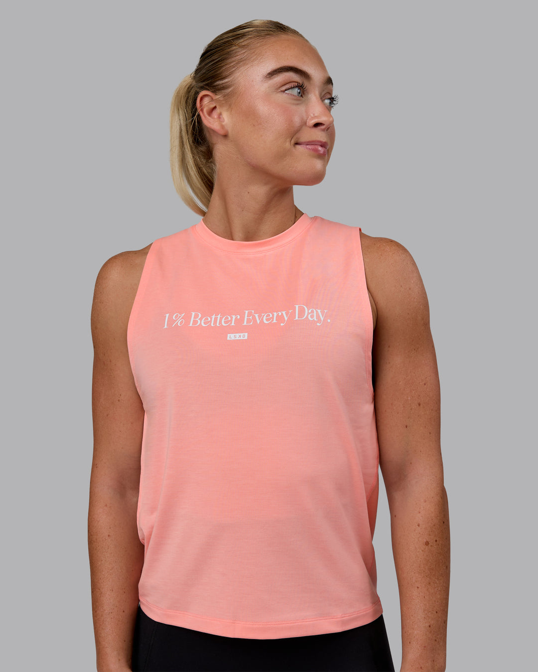 Woman wearing Unleash 1% Better Training Tank - Murex Shell-White