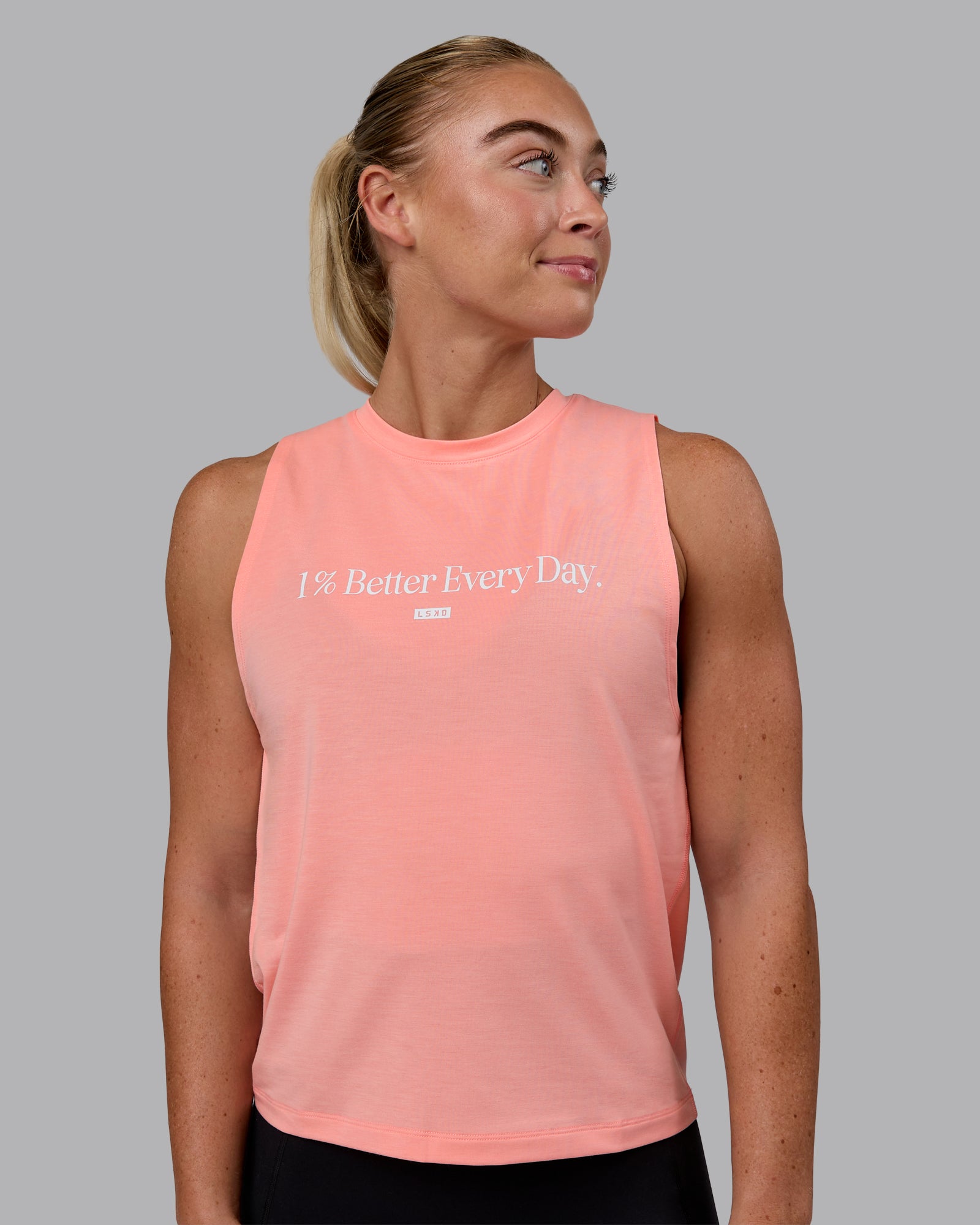 Woman wearing Unleash 1% Better Training Tank - Murex Shell-White