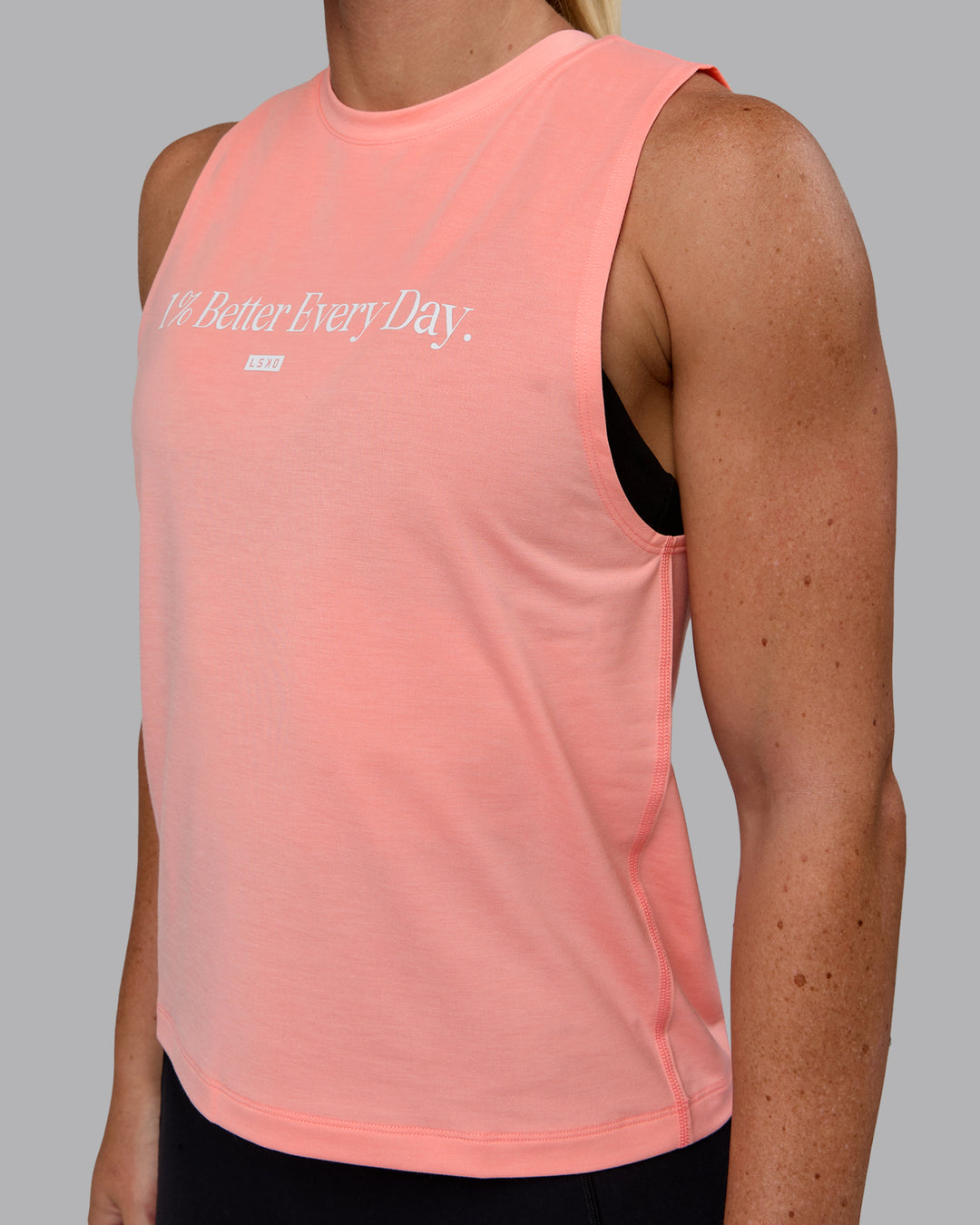 Woman wearing Unleash 1% Better Training Tank - Murex Shell-White