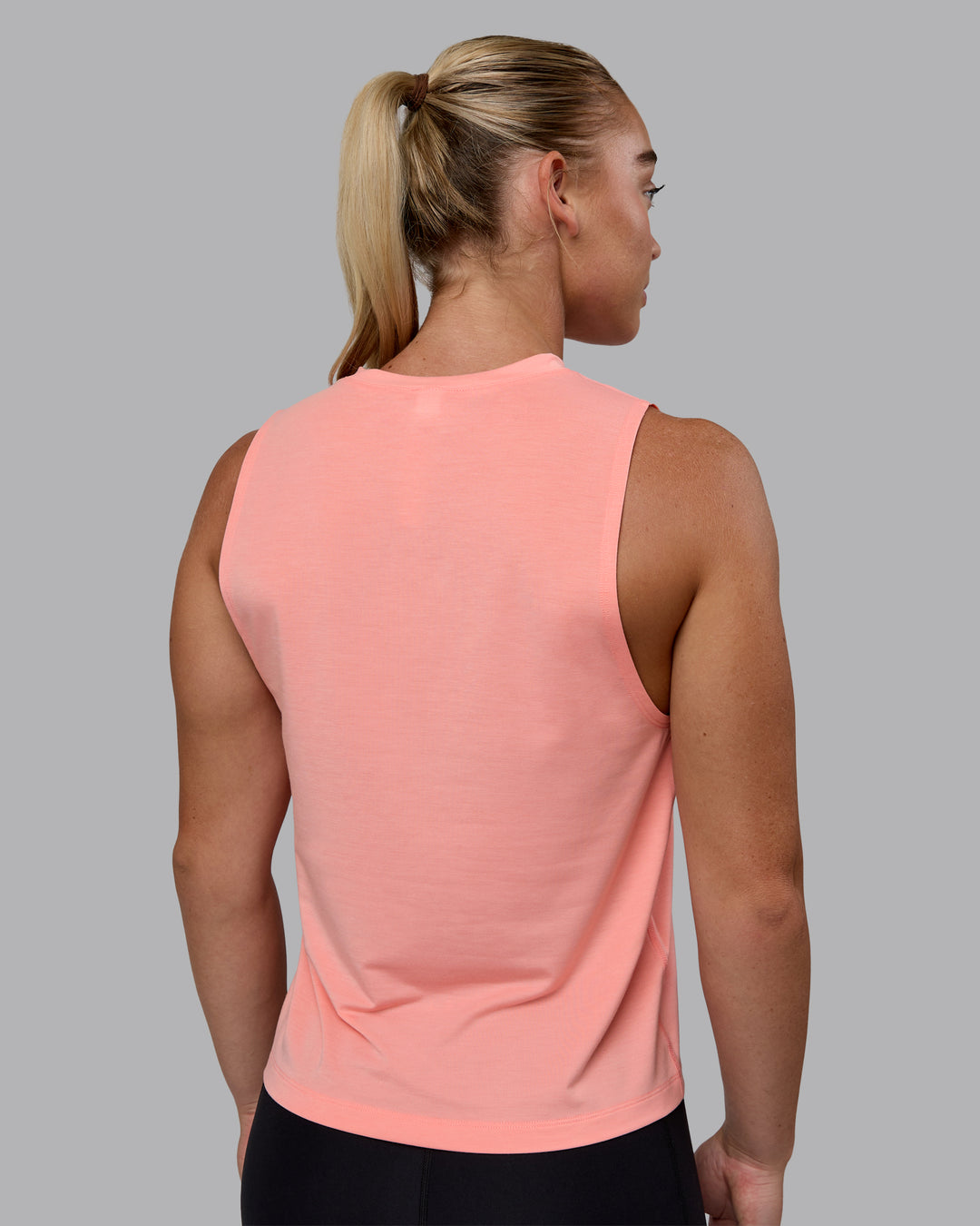 Woman wearing Unleash 1% Better Training Tank - Murex Shell-White