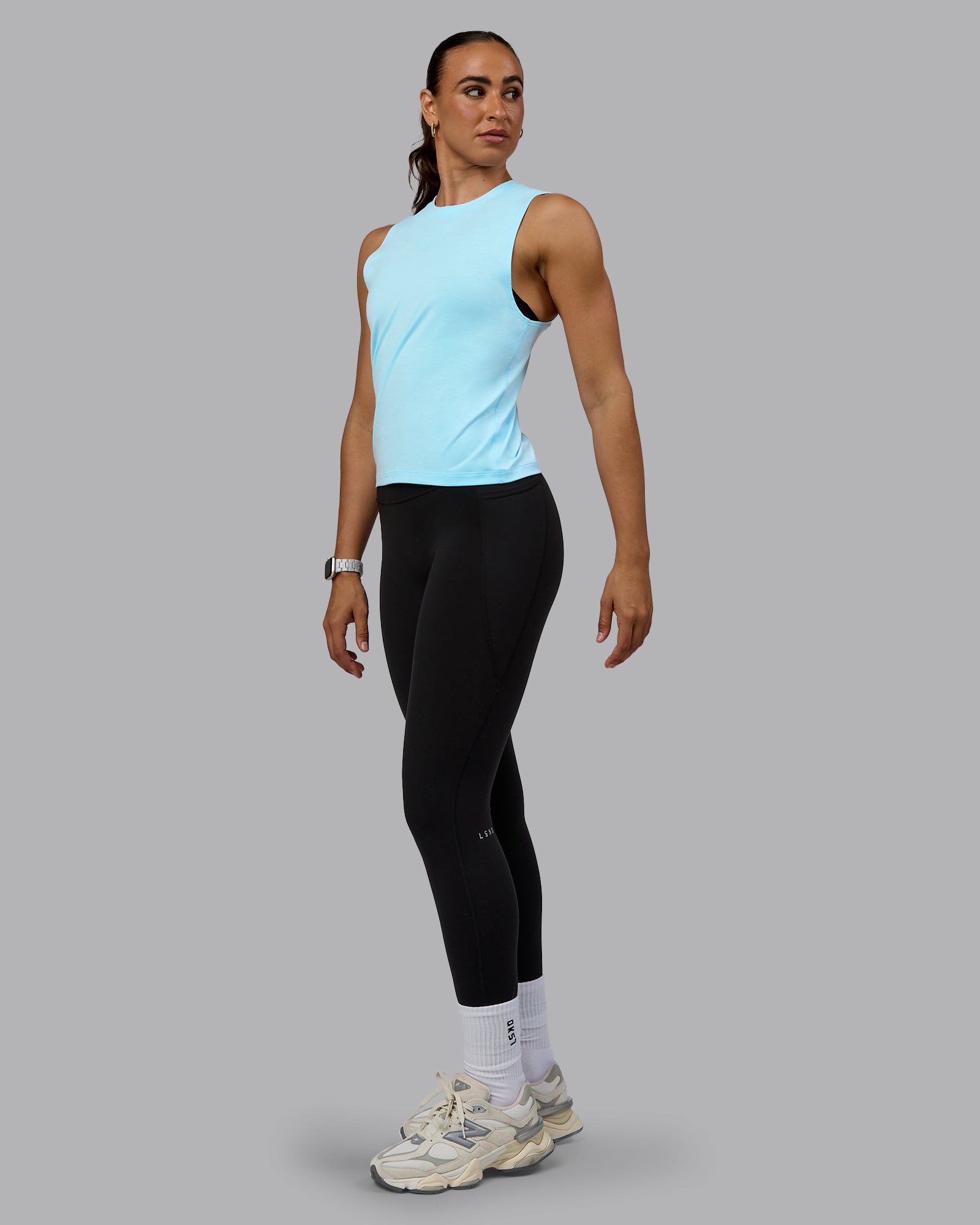Woman wearing Unleash Training Tank - Glacial Blue