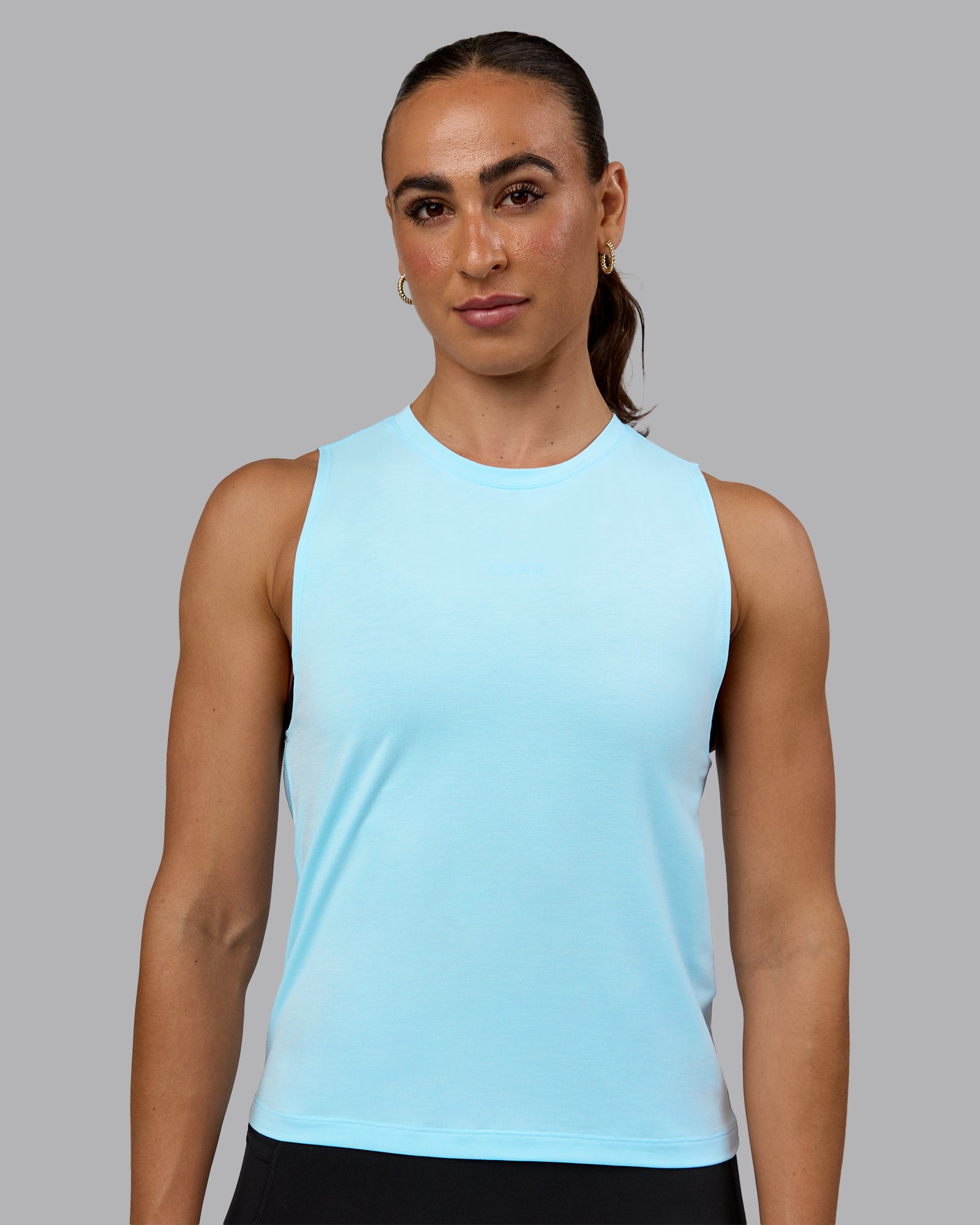 Woman wearing Unleash Training Tank - Glacial Blue
