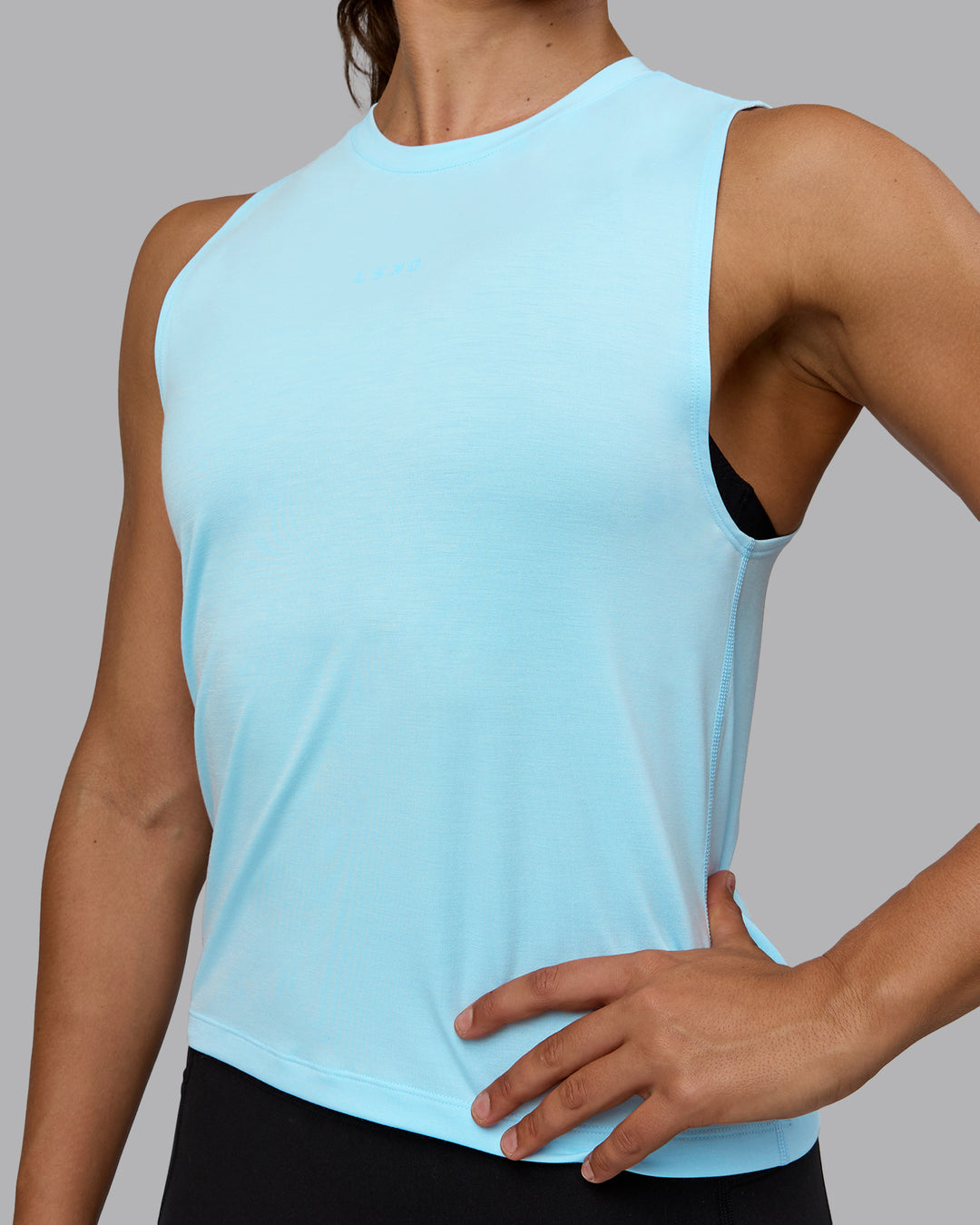 Woman wearing Unleash Training Tank - Glacial Blue