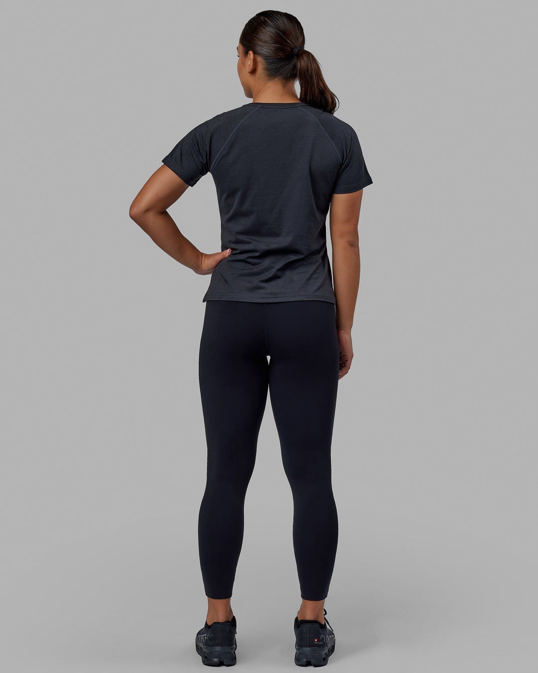Woman wearing Perform VapourFLX Tee - Black Marl