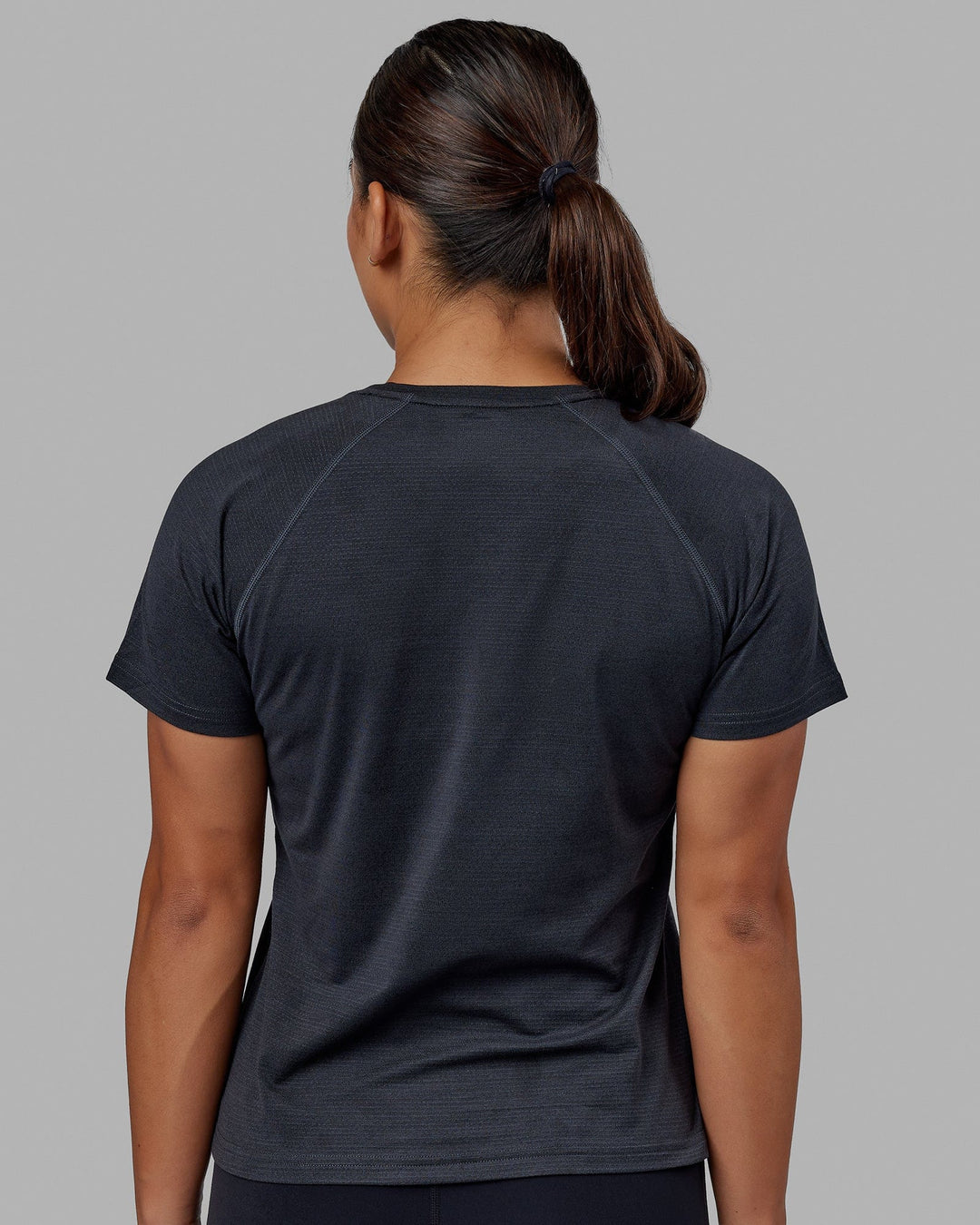 Woman wearing Perform VapourFLX Tee - Black Marl