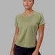 Woman wearing Perform VapourFLX Tee - Moss Stone Marl
