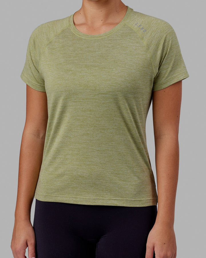 Woman wearing Perform VapourFLX Tee - Moss Stone Marl