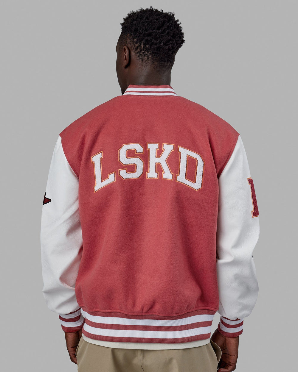 Man wearing Unisex Varsity Bomber Jacket - Mineral Red