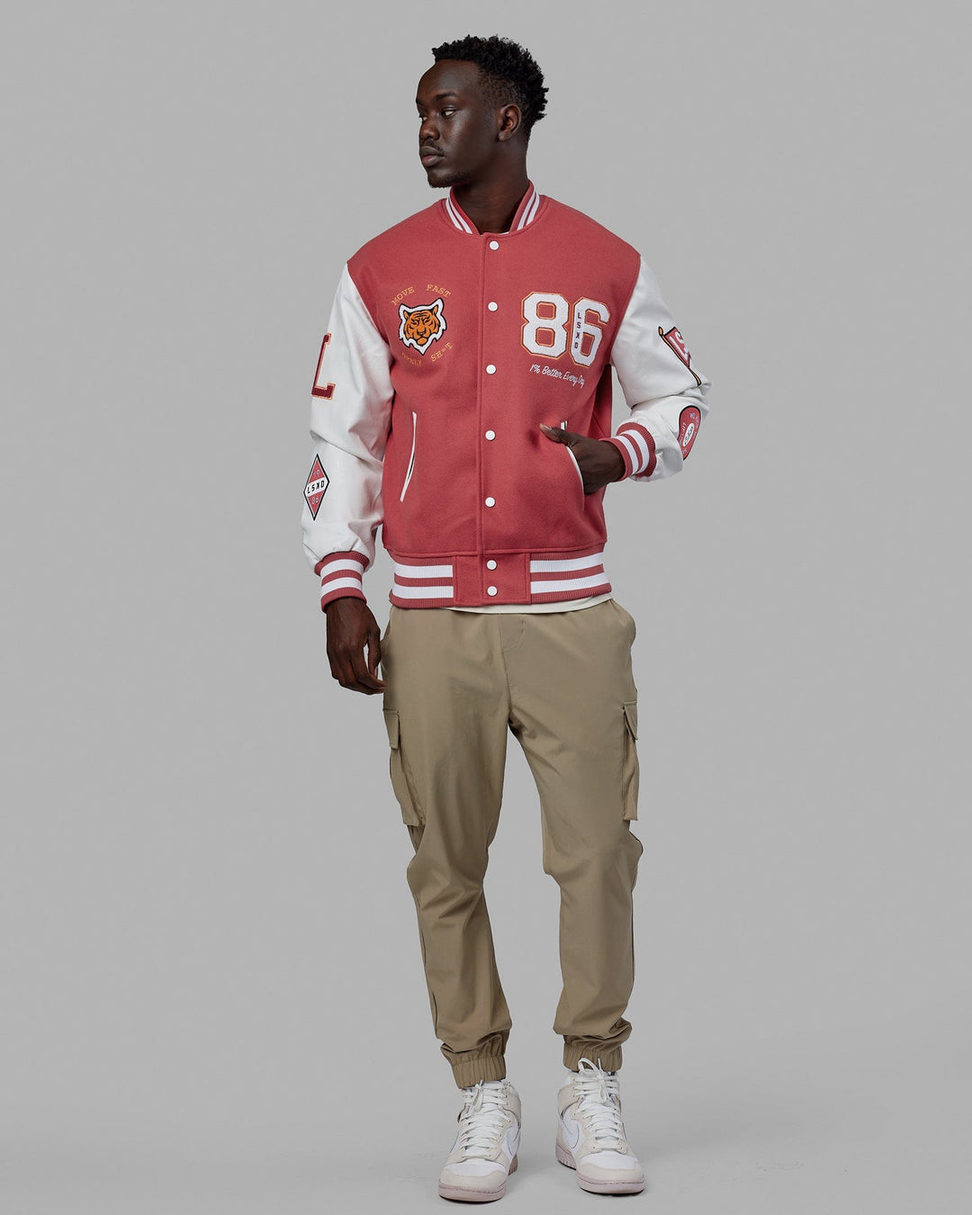 Man wearing Unisex Varsity Bomber Jacket - Mineral Red