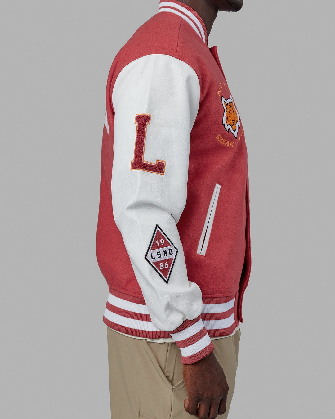 Man wearing Unisex Varsity Bomber Jacket - Mineral Red