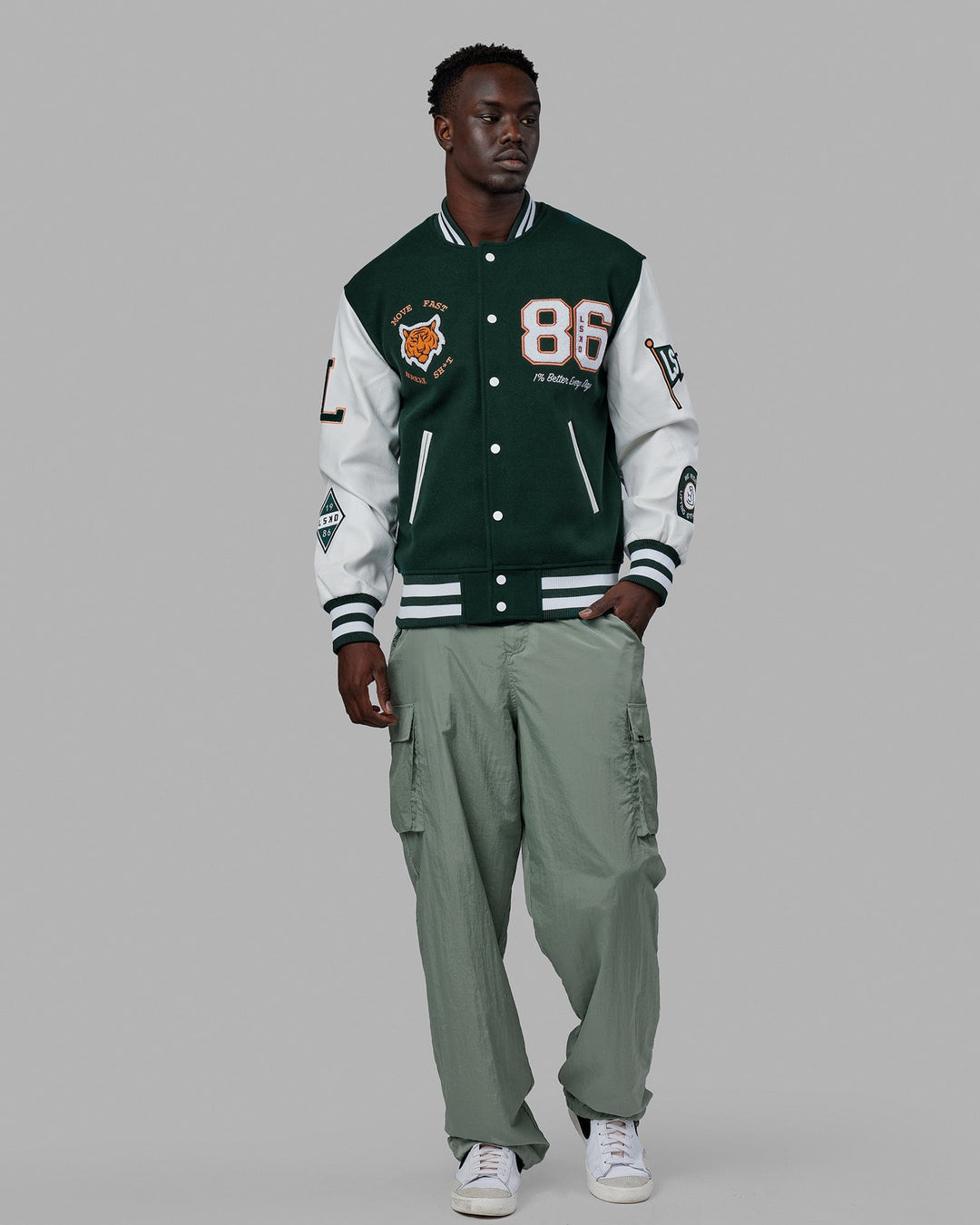 Man wearing Unisex Varsity Bomber Jacket - Vital Green
