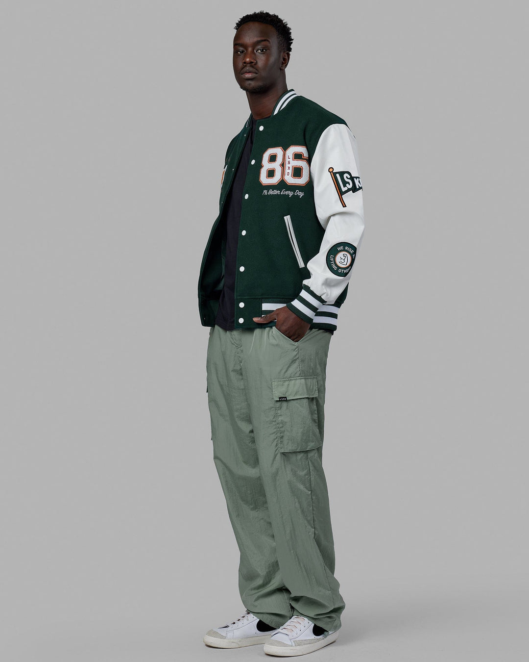 Man wearing Unisex Varsity Bomber Jacket - Vital Green