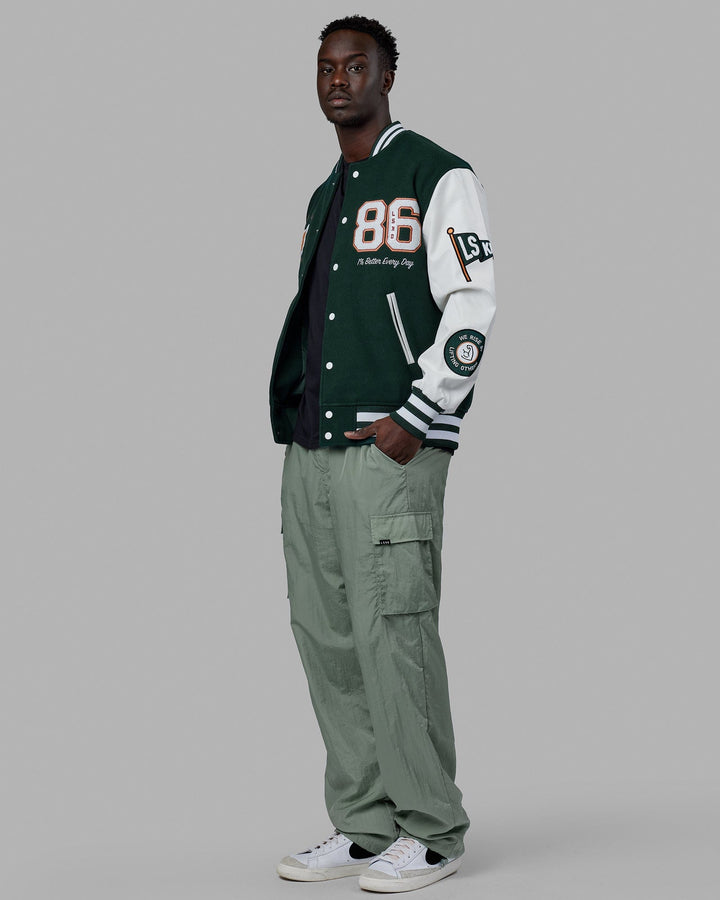 Man wearing Unisex Varsity Bomber Jacket - Vital Green