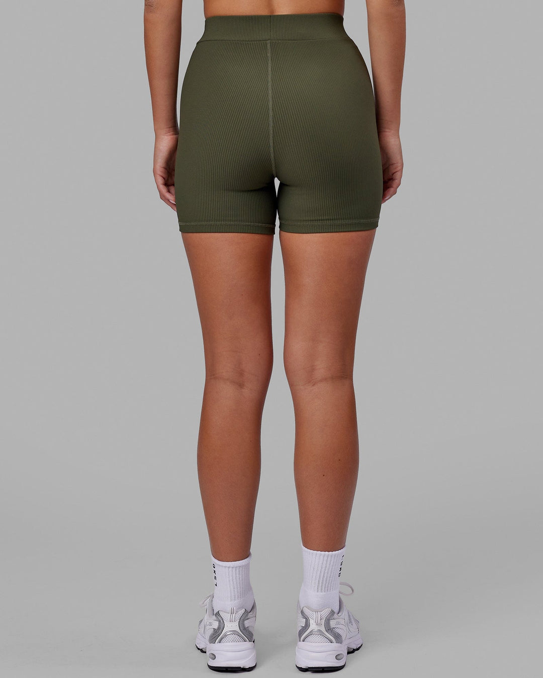 Woman wearing Vitalise Ribbed Mid Short - Forest Night