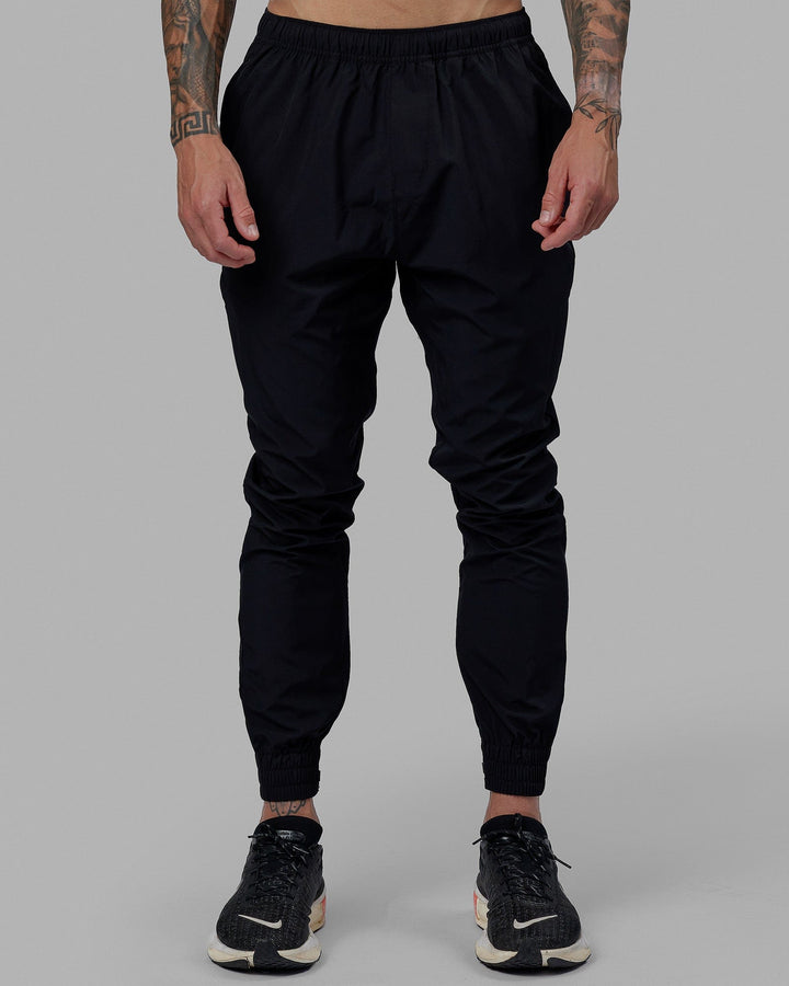 Man wearing Warm Up Zip Cuff Performance Pant - Black