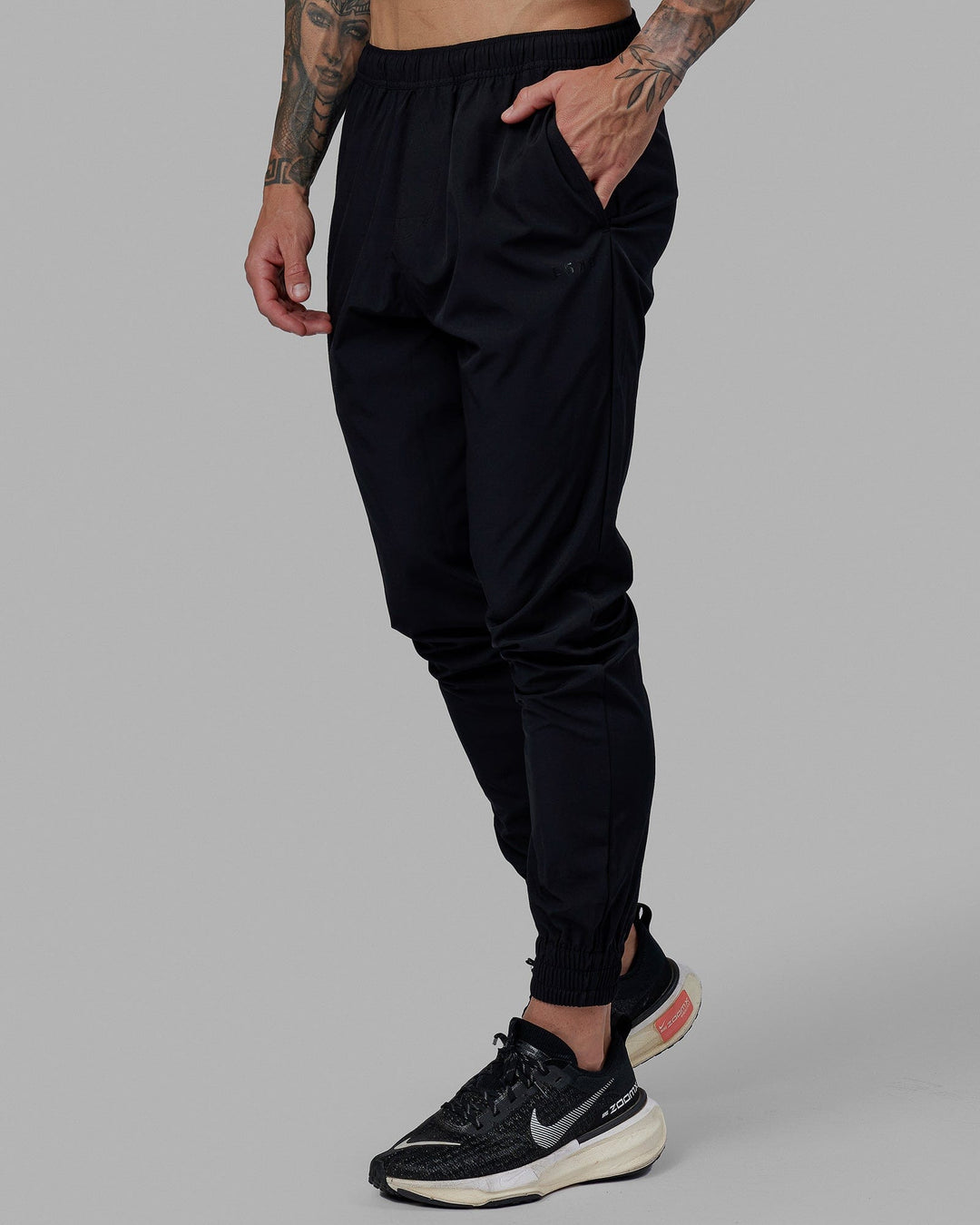Man wearing Warm Up Zip Cuff Performance Pant - Black
