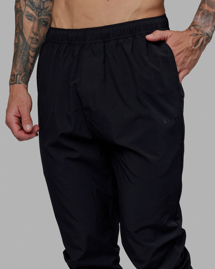 Man wearing Warm Up Zip Cuff Performance Pant - Black