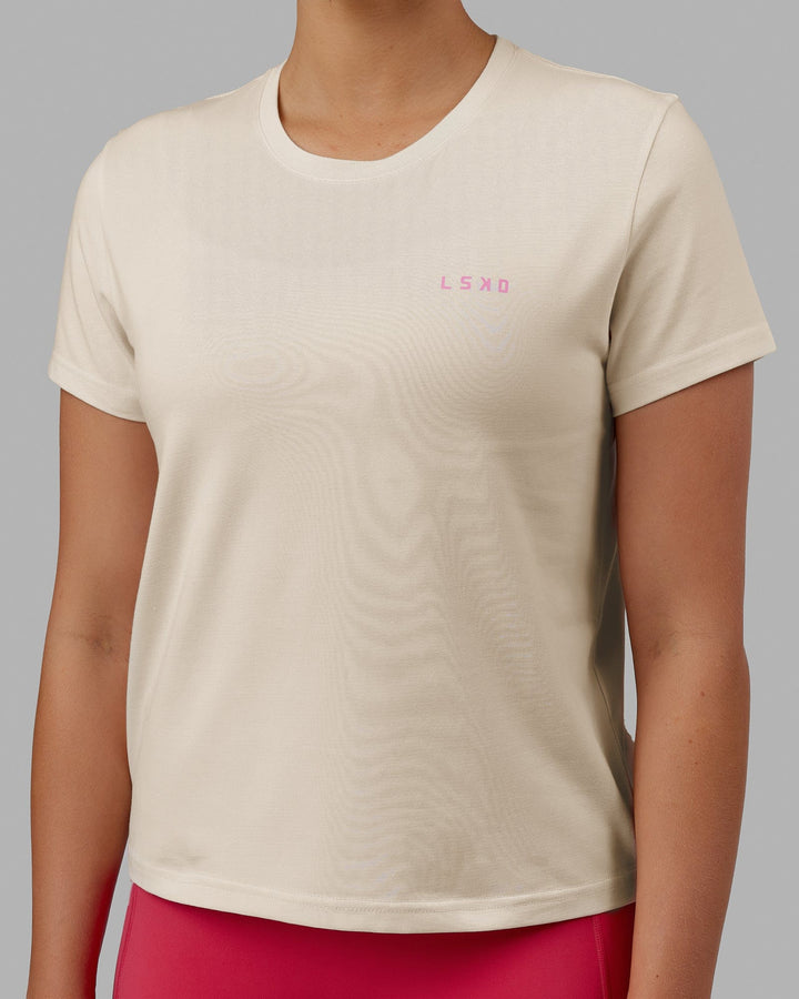 Woman wearing We Rise FLXCotton Tee - Cream