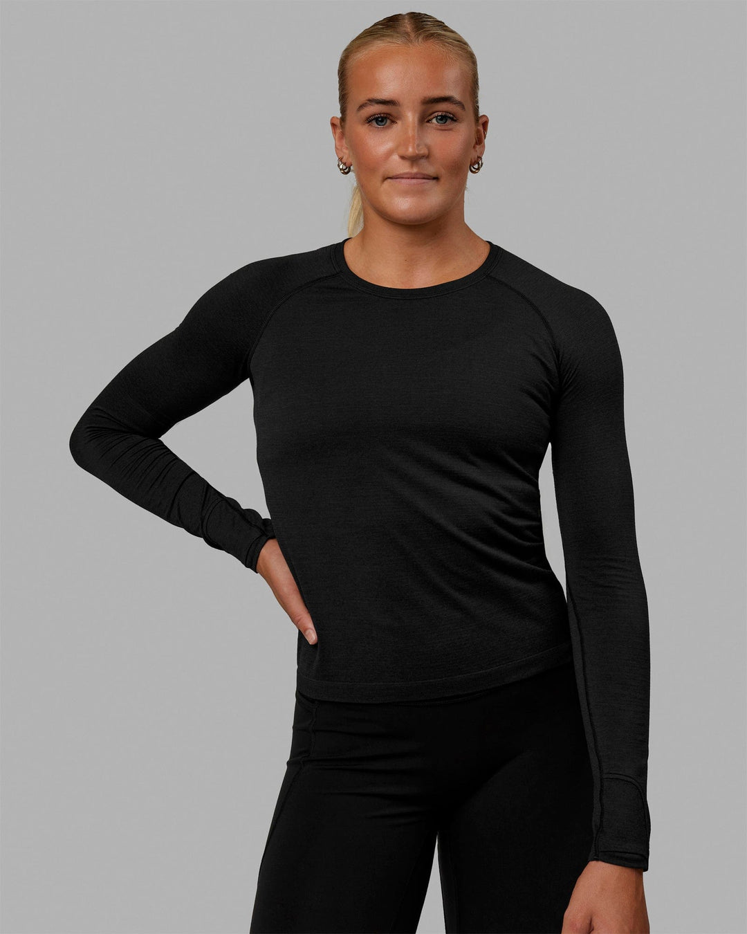 Woman wearing AeroFLX+ Seamless Long Sleeve Tee - Black Marl