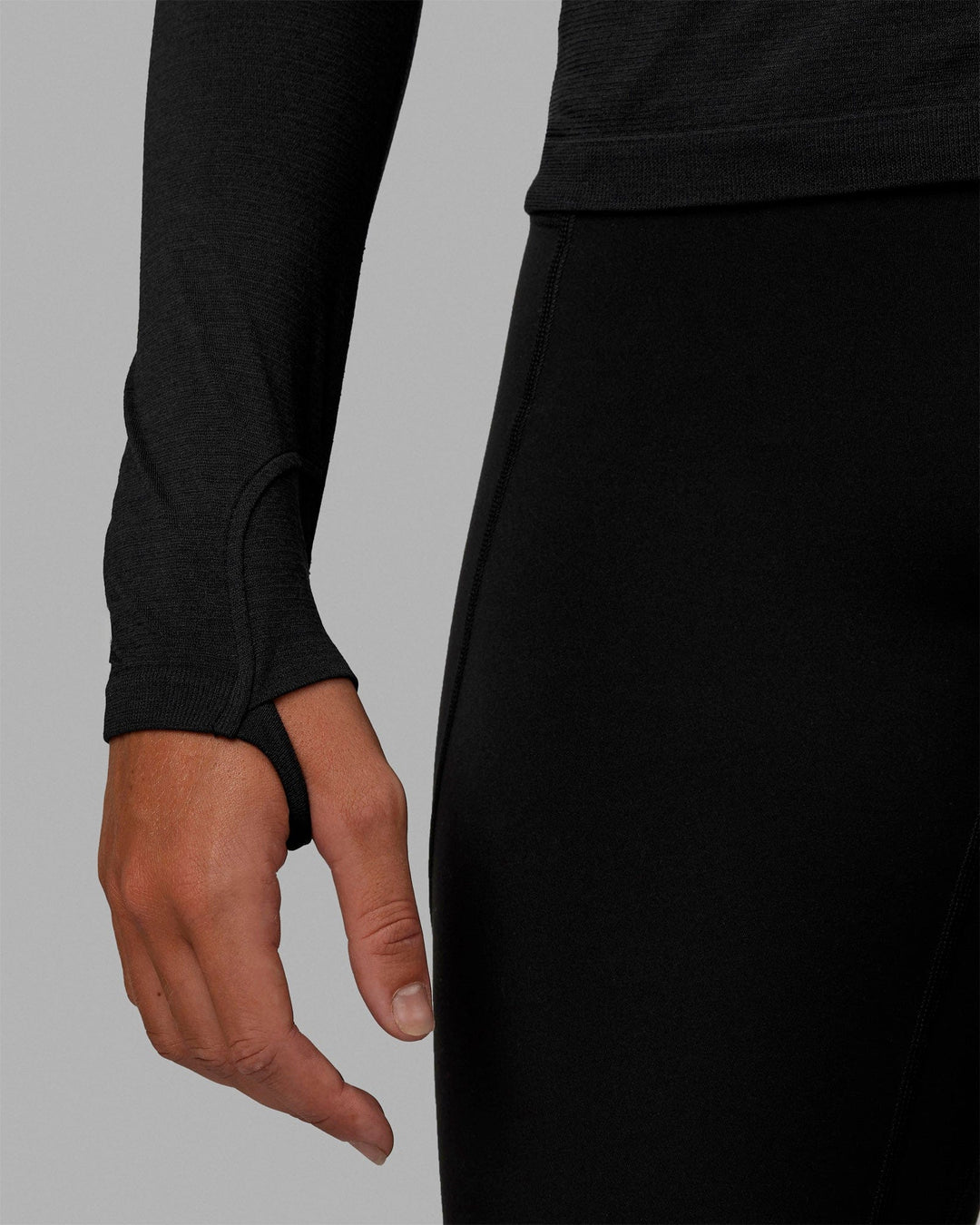 Woman wearing AeroFLX+ Seamless Long Sleeve Tee - Black Marl