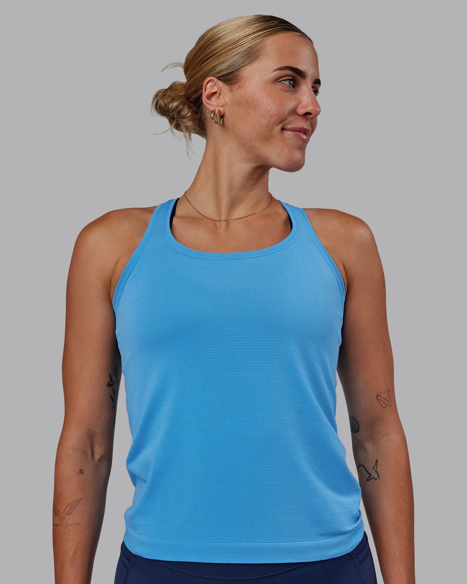 Woman wearing AeroFLX+ Seamless Tank - Azure Blue