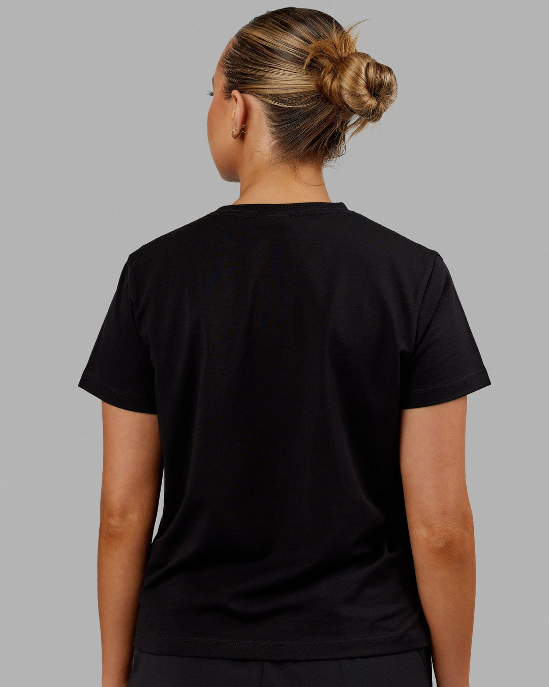 Woman wearing Deluxe PimaFLX Tee - Black