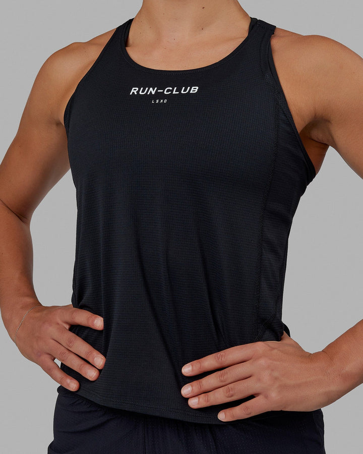 Woman wearing RUN–CLUB Performance Tank - Black-White